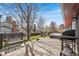 Spacious backyard with a well-maintained deck, hot tub, grill and mature trees at 8320 W Harvard Dr, Lakewood, CO 80227