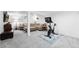Finished basement featuring a comfortable seating area with large sectional couch and exercise bike at 8320 W Harvard Dr, Lakewood, CO 80227