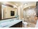 Bathroom showcasing a vanity with light blue countertop and a tiled walk-in shower at 8320 W Harvard Dr, Lakewood, CO 80227