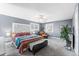 Spacious bedroom with decorative headboard and matching dressers, bright natural light and calming gray walls at 8320 W Harvard Dr, Lakewood, CO 80227