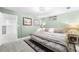 Calming bedroom in pale green with a bed, framed art, and a window to let in light at 8320 W Harvard Dr, Lakewood, CO 80227