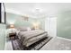 Calming green bedroom with a bed, area rug, lamps, and a small window for natural light at 8320 W Harvard Dr, Lakewood, CO 80227