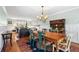 Light-filled dining room and living room featuring wood floors, modern wainscoting and a decorative vintage hutch at 8320 W Harvard Dr, Lakewood, CO 80227