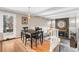 Cozy dining room with hardwood floors leading to a split staircase and fireplace at 8320 W Harvard Dr, Lakewood, CO 80227