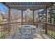 Cozy outdoor dining area with a charming gazebo and wrought iron table and chairs at 8320 W Harvard Dr, Lakewood, CO 80227