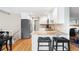 Open-concept kitchen featuring an island with stools, granite countertops, and stainless steel appliances at 8320 W Harvard Dr, Lakewood, CO 80227