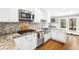 Well-appointed kitchen featuring granite countertops, stainless steel appliances, and ample white cabinetry at 8320 W Harvard Dr, Lakewood, CO 80227