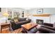 Comfortable living room with fireplace and cozy seating: a sofa and two leather armchairs at 8320 W Harvard Dr, Lakewood, CO 80227