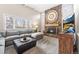 Living room with stone fireplace and rustic wood accents with a large sectional and wall mounted television at 8320 W Harvard Dr, Lakewood, CO 80227