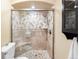 Bathroom showcasing a tiled shower with glass door and built-in bench seating at 8320 W Harvard Dr, Lakewood, CO 80227