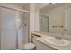 Bathroom featuring walk-in shower behind sliding glass door, and a well-lit vanity at 3494 S Eagle St # 202, Aurora, CO 80014