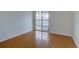 A bright bedroom with sleek wood flooring and a sliding glass door leads to the outside balcony at 3494 S Eagle St # 202, Aurora, CO 80014