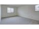 Spacious carpeted bedroom featuring natural light and ample open floor space at 3494 S Eagle St # 202, Aurora, CO 80014