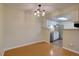 Dining room with hardwood floors and access to the kitchen with white cabinets and stainless steel appliances at 3494 S Eagle St # 202, Aurora, CO 80014