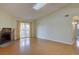 Bright living room with hardwood floors, stone fireplace, and sliding glass doors to a balcony at 3494 S Eagle St # 202, Aurora, CO 80014