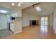 Open concept living space with hardwood floors, a stone fireplace, and access to a kitchen with white cabinets at 3494 S Eagle St # 202, Aurora, CO 80014