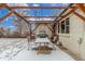 Covered patio area including table and chairs for outdoor living in winter at 3865 Independence Ct, Wheat Ridge, CO 80033