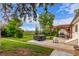 Expansive backyard featuring a hot tub, covered patio, barbecue area, and lush green lawn at 3865 Independence Ct, Wheat Ridge, CO 80033