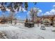 Spacious backyard with hot tub, patio and pergola covered in snow at 3865 Independence Ct, Wheat Ridge, CO 80033