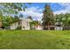Well-maintained backyard with green lawn, pergola, hot tub, and storage shed at 3865 Independence Ct, Wheat Ridge, CO 80033