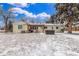 Backyard with house, hot tub, BBQ grill and covered pergola in winter at 3865 Independence Ct, Wheat Ridge, CO 80033