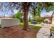 Cozy backyard featuring a shed, hot tub, pergola, and mature tree, perfect for outdoor relaxation and storage at 3865 Independence Ct, Wheat Ridge, CO 80033