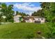 Expansive backyard featuring lush lawn and outdoor entertaining space with pergola and hot tub at 3865 Independence Ct, Wheat Ridge, CO 80033
