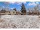 Spacious, snow-covered backyard with shed and pergola, perfect for outdoor activities at 3865 Independence Ct, Wheat Ridge, CO 80033