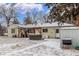 Backyard featuring a hot tub, grill and covered patio area in winter at 3865 Independence Ct, Wheat Ridge, CO 80033