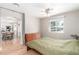 Bedroom with hardwood floors, ceiling fan, and natural light, leading to an adjacent dining area at 3865 Independence Ct, Wheat Ridge, CO 80033