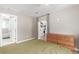 Bedroom next to bathroom and kitchen area, with hardwood floors and a neutral color palette at 3865 Independence Ct, Wheat Ridge, CO 80033