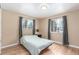 Bedroom with hardwood floors, two windows for natural light, and neutral wall paint at 3865 Independence Ct, Wheat Ridge, CO 80033