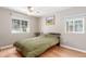 Cozy bedroom with hardwood floors, two windows for natural light, and neutral wall paint at 3865 Independence Ct, Wheat Ridge, CO 80033