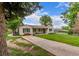 A charming white brick home with dark shutters, bench seating and a well-kept lawn at 3865 Independence Ct, Wheat Ridge, CO 80033