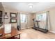 A comfortable home office area with a treadmill, desk and bright windows at 3865 Independence Ct, Wheat Ridge, CO 80033