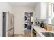 Kitchen area featuring stainless steel appliances and in-unit washer/dryer area at 3865 Independence Ct, Wheat Ridge, CO 80033