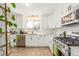 Modern kitchen with white cabinets, stainless steel appliances, and ample counter space at 3865 Independence Ct, Wheat Ridge, CO 80033