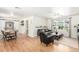 Bright living room with hardwood floors, a ceiling fan, and a large window with natural light at 3865 Independence Ct, Wheat Ridge, CO 80033