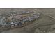 An expansive aerial shot captures a community of suburban homes nestled in a prairie landscape at 4738 River Highlands Loop, Elizabeth, CO 80107