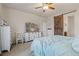 Comfortable bedroom features a ceiling fan, flat screen television and sliding barn door at 4738 River Highlands Loop, Elizabeth, CO 80107