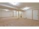 A large basement with beige carpet, neutral paint, and a stairway at 8055 S Zephyr Way, Littleton, CO 80128