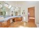 Bright bathroom featuring dual vanities, tile counters and natural light at 8055 S Zephyr Way, Littleton, CO 80128