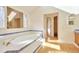 Bathroom featuring a large soaking tub and storage shelves at 8055 S Zephyr Way, Littleton, CO 80128