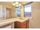 Bathroom featuring a sink and vanity area illuminated by two large windows and pendant lights at 8055 S Zephyr Way, Littleton, CO 80128