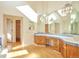 Spacious bathroom featuring dual vanities, wood cabinets, and ample counter space at 8055 S Zephyr Way, Littleton, CO 80128