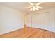 Bedroom features hardwood floors, closet, and ceiling fan at 8055 S Zephyr Way, Littleton, CO 80128
