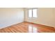 Bedroom featuring hardwood floors and a window providing ample natural light at 8055 S Zephyr Way, Littleton, CO 80128