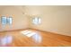 Bright bedroom featuring hardwood floors and several windows at 8055 S Zephyr Way, Littleton, CO 80128