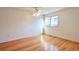 Bright bedroom featuring hardwood floors, ceiling fan and window with views at 8055 S Zephyr Way, Littleton, CO 80128