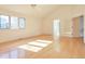 Bedroom with hardwood flooring, double doors, and three windows at 8055 S Zephyr Way, Littleton, CO 80128